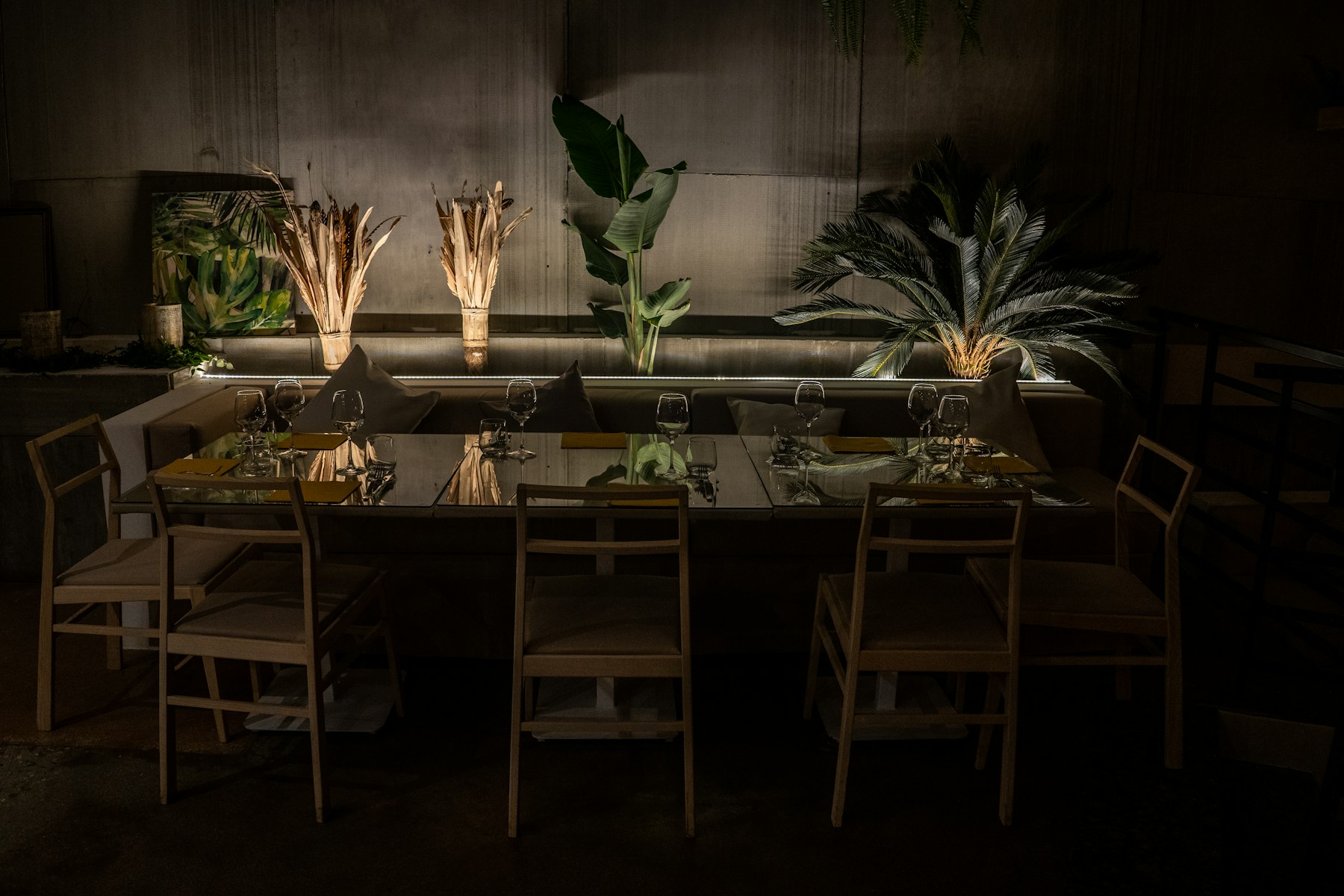 Atelier Norr studio: long wooden table and chairs in low light