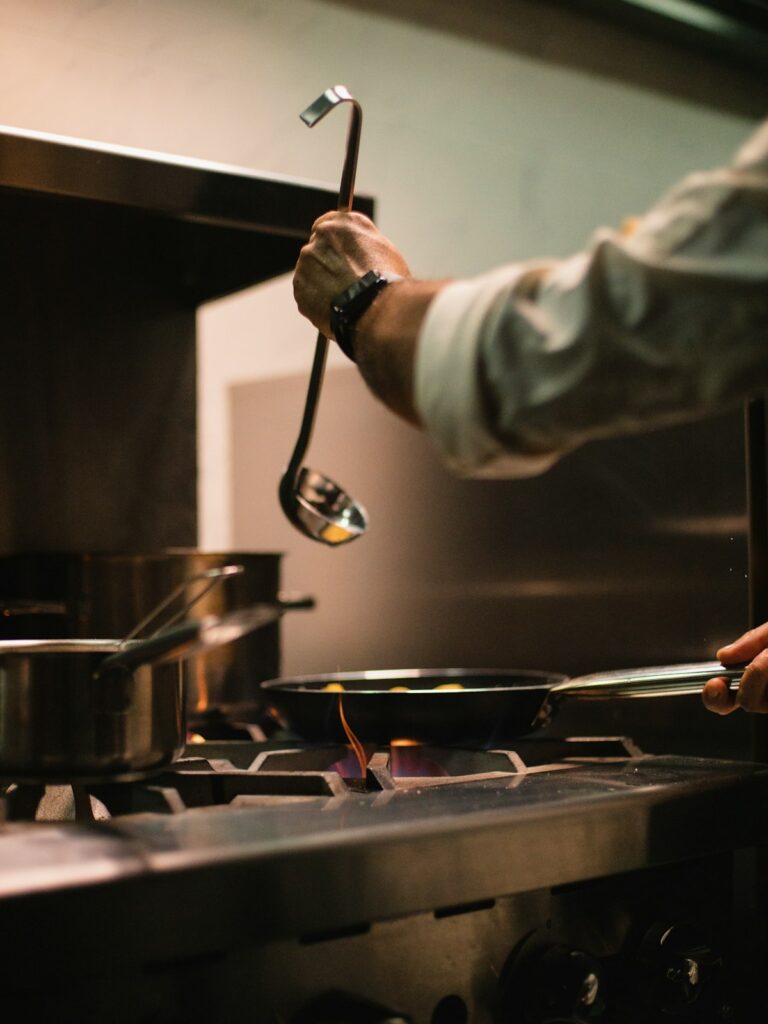 Chef Elena Marsh plating a dish in the Harvest & Oak kitchen